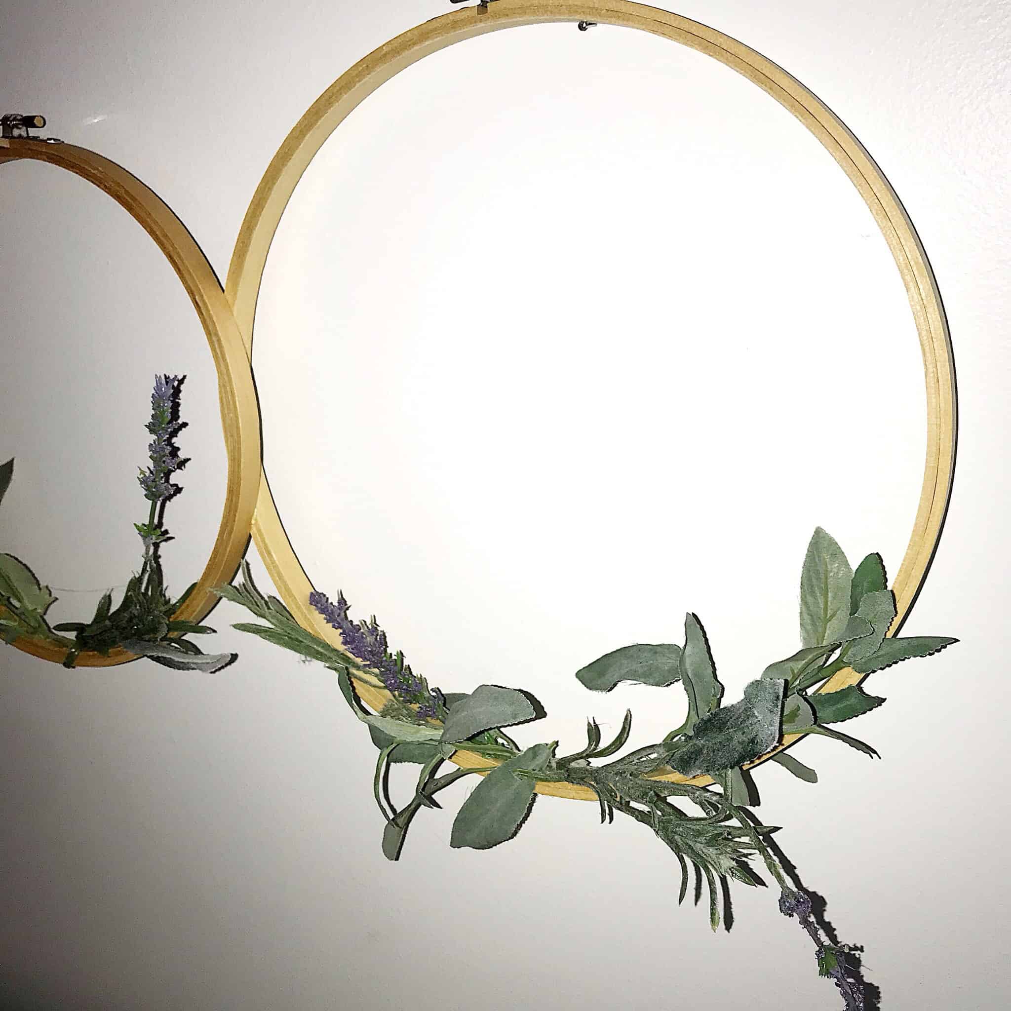 I love this Spring Wreath. It's the cutest embroidery hoop wreath wall hanging. The greenery and floral on it adds so much character. This new trend is so fun. This is such an easy Spring home decor project. You will love making your own diy spring wreath. It's affordable and barely costs anything. #diyhoopwreath #diyembroideryhoopwreath #embroideryhoopwreath #diyspringwreath