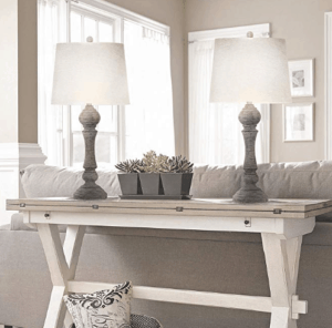 2 Gray skinny lamps sitting on white console table