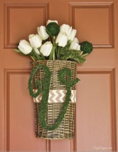 white tulips in basket hanging on front door